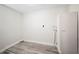 This laundry room features light gray vinyl flooring and white walls, offering a clean, modern look at 1126 Waterview E Blvd, Lakeland, FL 33801