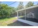 Relaxing screened porch extending from the home, overlooking the spacious and green backyard at 1126 Waterview E Blvd, Lakeland, FL 33801