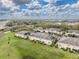 Aerial view of homes with landscaped green space and a parking lot at 5335 River Rock Rd, Lakeland, FL 33809