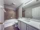 Bathroom with shower and tub, toilet, sink and countertop, and large mirror at 5335 River Rock Rd, Lakeland, FL 33809