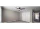 Bedroom with ceiling fan, carpeted floor, and a closet with white doors at 5335 River Rock Rd, Lakeland, FL 33809