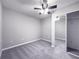 Bedroom with ceiling fan and mirrored closet doors over gray carpet floor at 5335 River Rock Rd, Lakeland, FL 33809