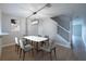 Open dining room featuring modern light fixture, grey chairs and stairs to the second floor at 5335 River Rock Rd, Lakeland, FL 33809