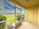 View from a screened patio overlooking green grass and landscaping under a blue sky at 5335 River Rock Rd, Lakeland, FL 33809