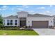 Charming single-story home featuring a well-manicured lawn and a welcoming two-car garage at 5646 Nevis Ter, Kissimmee, FL 34758