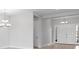 Bright foyer with double doors and contemporary lighting fixtures at 5646 Nevis Ter, Kissimmee, FL 34758