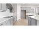 Modern kitchen featuring gray cabinets, stainless steel appliances, and hardwood floors at 5646 Nevis Ter, Kissimmee, FL 34758