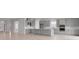 Spacious open-concept kitchen with large island, stainless appliances, and light wood flooring at 5646 Nevis Ter, Kissimmee, FL 34758