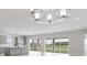 Open-concept kitchen and living space with modern grey cabinets and large glass sliding doors to back yard at 5646 Nevis Ter, Kissimmee, FL 34758
