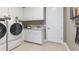 Laundry room with a sink, cabinetry, and modern washer and dryer at 5646 Nevis Ter, Kissimmee, FL 34758