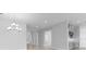 Living room features a modern chandelier and an open floor plan at 5646 Nevis Ter, Kissimmee, FL 34758