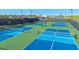 Aerial view of blue and green community pickleball courts with lighting for evening play at 5646 Nevis Ter, Kissimmee, FL 34758