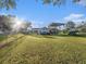 Vast, sunlit backyard featuring a shed, carport, boat, and well-maintained lawn at 915 E Lake Parker Dr, Lakeland, FL 33801