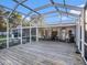 Wide angle view of a backyard deck, a screened in patio and outdoor furniture at 915 E Lake Parker Dr, Lakeland, FL 33801