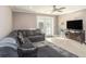 Inviting living room featuring a comfortable sectional sofa, modern ceiling fan, and french doors at 915 E Lake Parker Dr, Lakeland, FL 33801