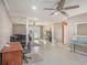 Open living room with tile flooring, ceiling fans, columns, and neutral paint at 915 E Lake Parker Dr, Lakeland, FL 33801