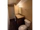 Bathroom featuring granite countertop, dark wood cabinet, and white toilet at 1135 Linkside Ct, Apopka, FL 32712