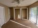 Bright bedroom with open closets and sliding glass doors, filling the space with natural light at 1135 Linkside Ct, Apopka, FL 32712