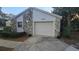Charming exterior elevation featuring a one-car garage and stone accents on the front of the home at 1135 Linkside Ct, Apopka, FL 32712