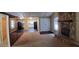 Spacious living area with a stone fireplace, open to a kitchen space, perfect for entertaining at 1135 Linkside Ct, Apopka, FL 32712
