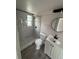 Updated bathroom with modern vanity, stylish mirror, and glass-enclosed shower with marble tiling at 1460 Marvin C Zanders Ave, Apopka, FL 32703