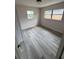 Cozy bedroom features wood-look flooring, with two windows providing ample natural light at 1460 Marvin C Zanders Ave, Apopka, FL 32703