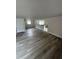 Spacious living room featuring updated flooring and lots of natural light at 1460 Marvin C Zanders Ave, Apopka, FL 32703