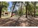 Peaceful backyard with mature trees and a charming turret-style building at 9114 Cr 647A, Bushnell, FL 33513