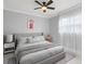 Inviting bedroom featuring soft gray tones, neutral bedding, and sheer white curtains at 226 Selkirk Way, Longwood, FL 32779