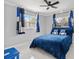 Cozy bedroom with a blue comforter, stylish curtains, and large windows at 226 Selkirk Way, Longwood, FL 32779