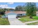 Charming one-story home featuring manicured lawn, attached garage, and brick accents at 226 Selkirk Way, Longwood, FL 32779