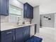 Updated kitchen featuring stainless steel dishwasher, sink, and ample storage with dark blue cabinetry at 226 Selkirk Way, Longwood, FL 32779