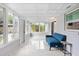 Bright sunroom with tiled ceiling, lots of windows, and a blue accent sofa at 226 Selkirk Way, Longwood, FL 32779