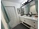 Bathroom vanity with large mirror, decorative seahorse art and modern fixtures at 4513 Yorkshire Ln, Kissimmee, FL 34758