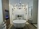 Bright and stylish bathroom featuring a freestanding tub and modern fixtures at 4513 Yorkshire Ln, Kissimmee, FL 34758