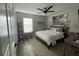 Bedroom with ceiling fan, large window, and beach-themed decor at 4513 Yorkshire Ln, Kissimmee, FL 34758