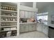 Bright kitchen featuring white cabinetry, open shelving pantry, and modern countertops at 4513 Yorkshire Ln, Kissimmee, FL 34758