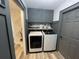 Well-organized laundry room with gray cabinetry and modern washer and dryer at 4513 Yorkshire Ln, Kissimmee, FL 34758