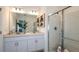 Bright bathroom showcasing a dual vanity, large mirror, and glass shower at 1908 Rosewood Cir, Lakeland, FL 33810