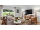 Bright living room with a large sectional sofa, stylish decor, and a view of the outdoors, perfect for relaxation at 1908 Rosewood Cir, Lakeland, FL 33810