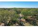 An aerial shot features a cozy home surrounded by lush, mature trees at 2920 Ewell Rd, Lakeland, FL 33811