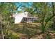 Backyard view of a white home featuring a screened in porch and plenty of room to roam at 2920 Ewell Rd, Lakeland, FL 33811