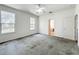 Bright bedroom with two windows, ceiling fan, and access to a bathroom at 2920 Ewell Rd, Lakeland, FL 33811