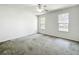 Spacious bedroom with two windows and a ceiling fan with light at 2920 Ewell Rd, Lakeland, FL 33811