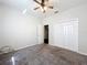 Cozy bedroom with neutral carpet, ceiling fan, and ample closet space at 2920 Ewell Rd, Lakeland, FL 33811