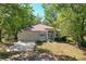 Charming single-story home featuring a well-manicured lawn, mature trees, and a cozy facade at 2920 Ewell Rd, Lakeland, FL 33811