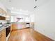 Eat-in kitchen area with wood floors, plenty of counterspace, and updated appliances at 2920 Ewell Rd, Lakeland, FL 33811