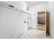 Practical laundry room with shelving, hookups, and door leading to the garage at 2920 Ewell Rd, Lakeland, FL 33811
