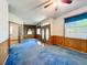 Open-concept living room features double doors, wood paneled wainscoting, and lots of natural light at 2920 Ewell Rd, Lakeland, FL 33811