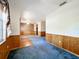 Spacious living area with wood paneled wainscoting, blue carpeting and great open floor plan at 2920 Ewell Rd, Lakeland, FL 33811